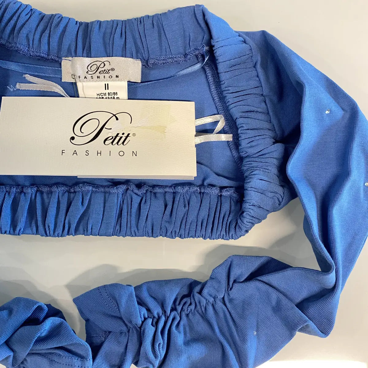Coprispalle elegante in cotone colore azzurro con strass